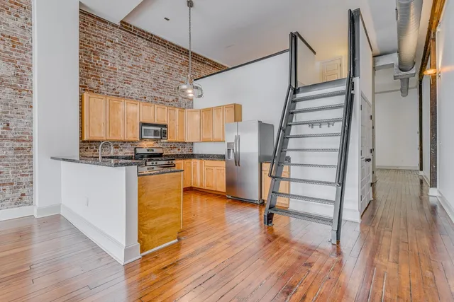 an empty room with closet and natural light