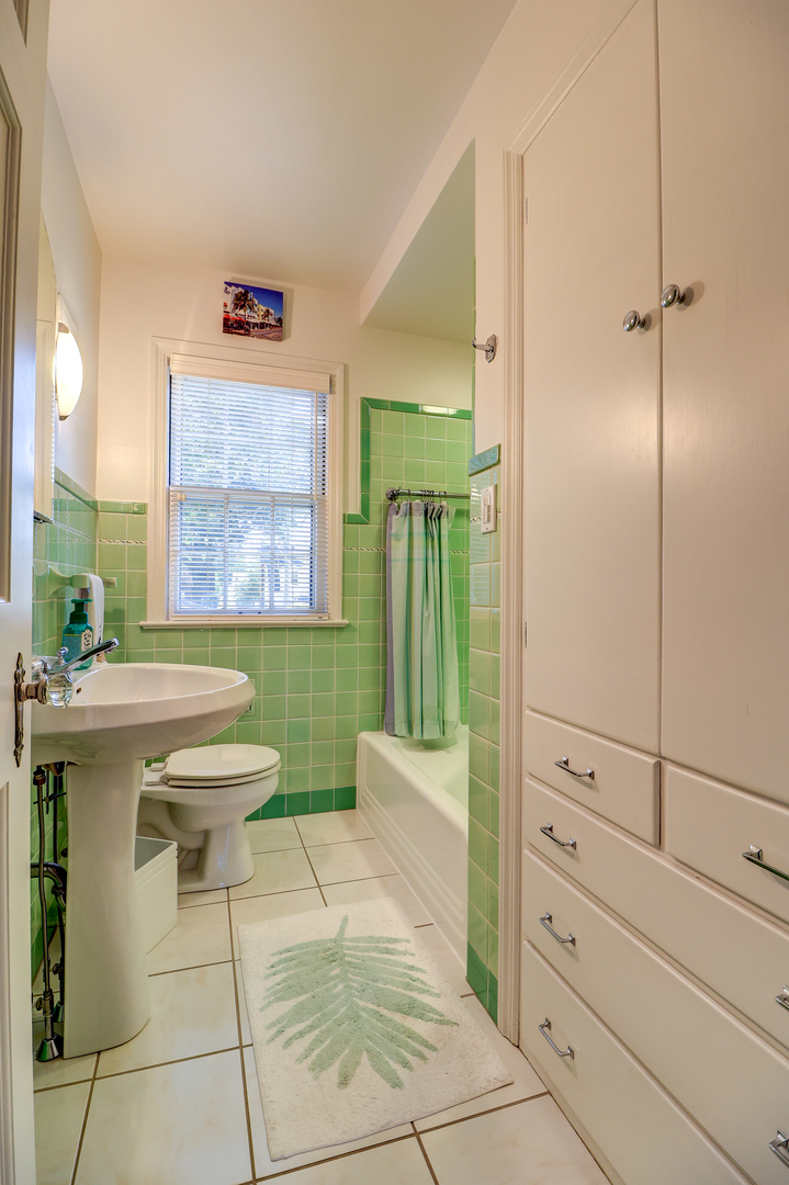 411 West 13th Street Sterling, IL 61081 - Photo 26 of 53 a spacious bathroom with a toilet a sink and mirror