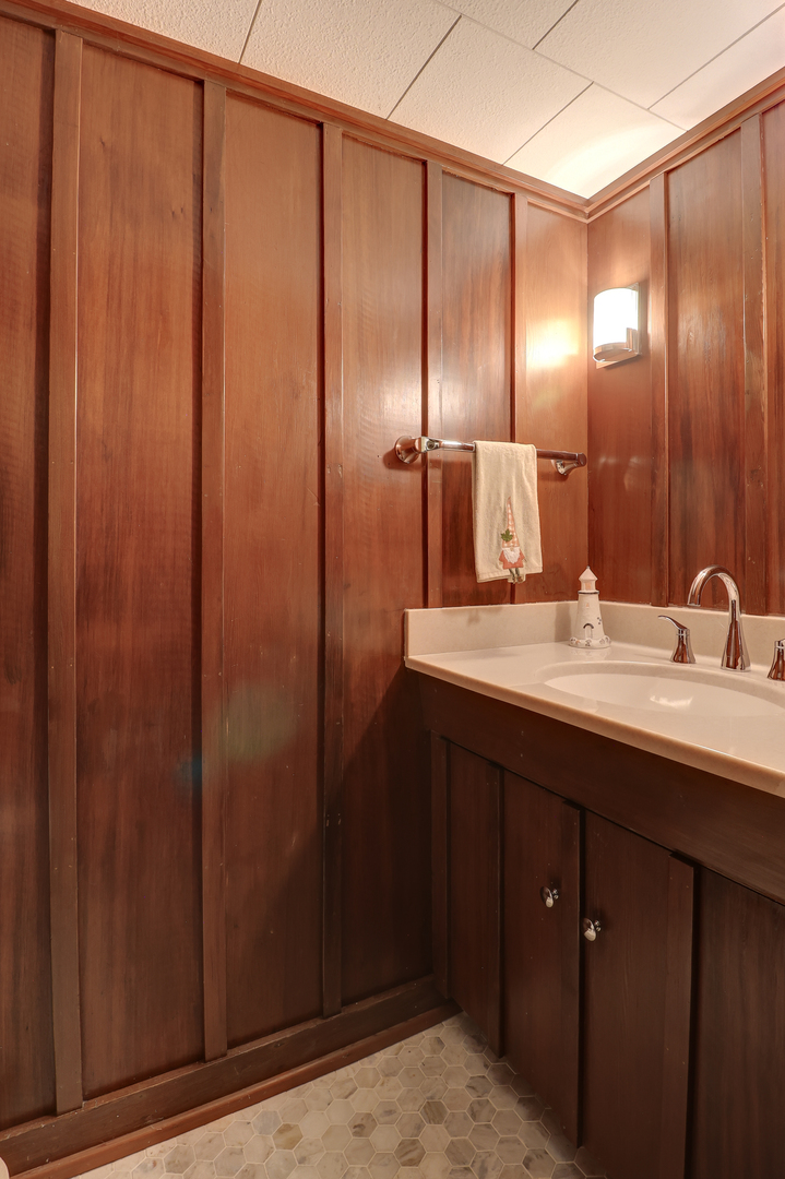 411 West 13th Street Sterling, IL 61081 - Photo 32 of 53 a bathroom with a double vanity sink and a mirror