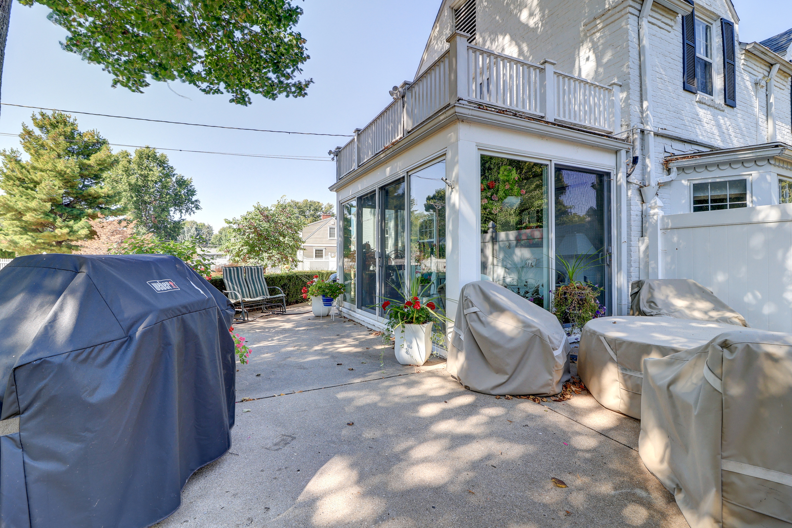 411 West 13th Street Sterling, IL 61081 - Photo 35 of 53 a view of a patio with table and chairs potted plants