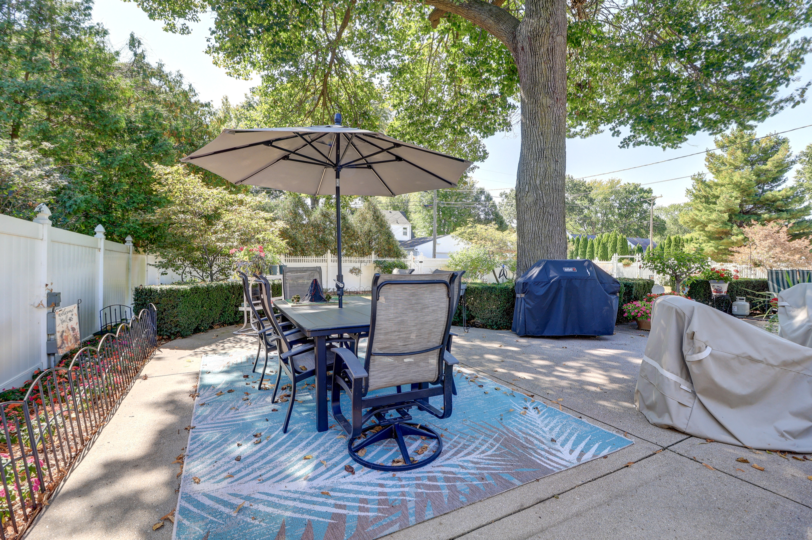 411 West 13th Street Sterling, IL 61081 - Photo 36 of 53 a view of a patio with a table chairs and a umbrella