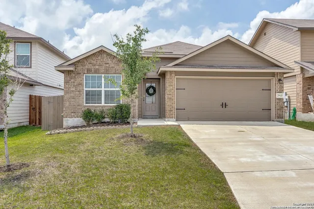 a view of a house with a yard and garage