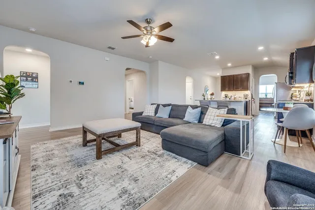 a living room with furniture a rug and a chandelier