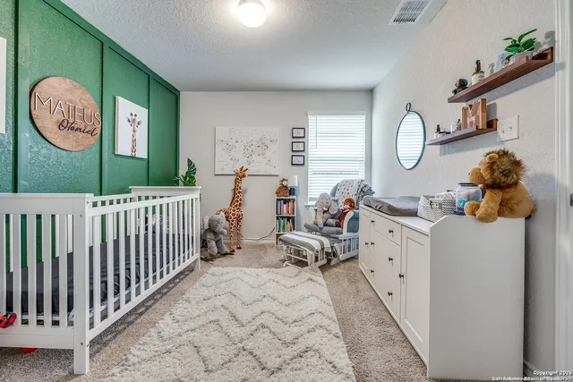 a bedroom with furniture and a large window