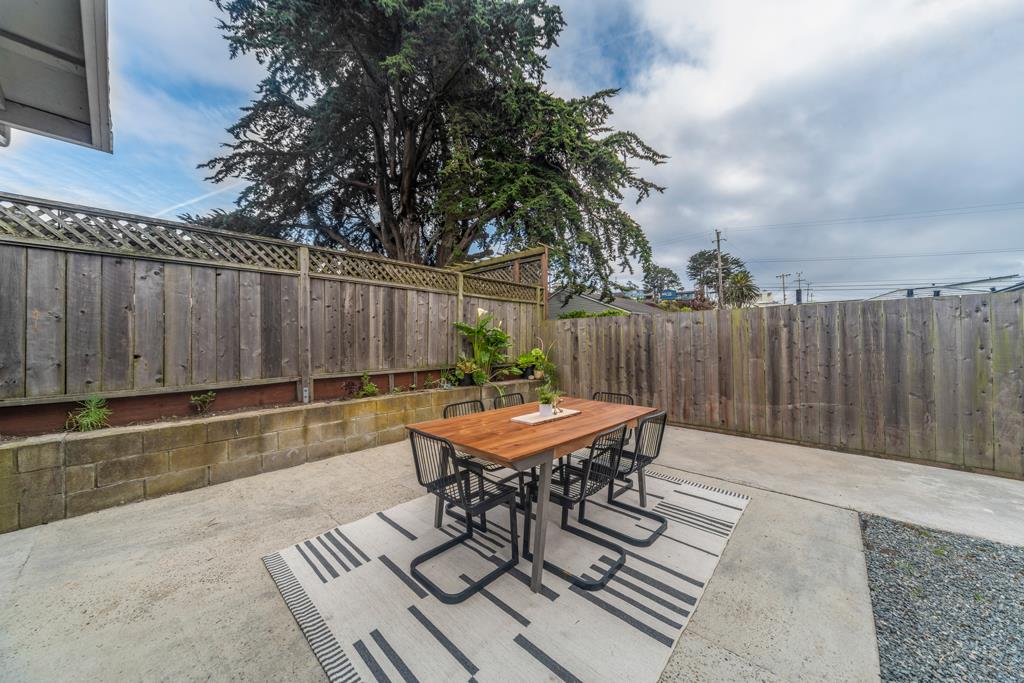 370 Monterey Road Pacifica, CA 94044 - Photo 21 of 31 a backyard of a house with dining table and chairs