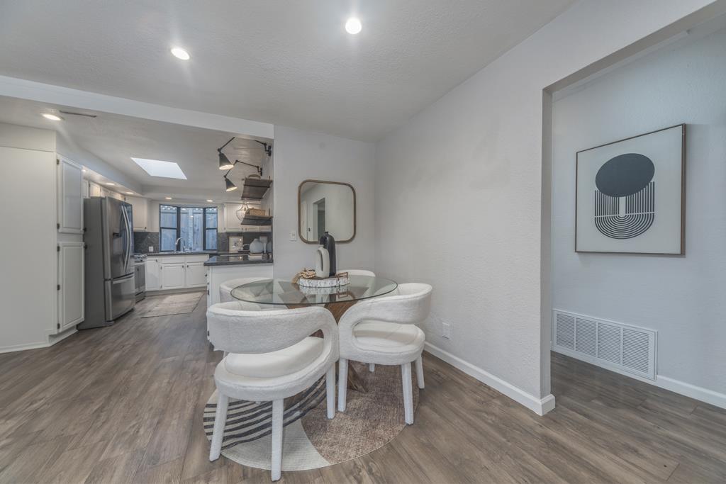 370 Monterey Road Pacifica, CA 94044 - Photo 5 of 31 a dining room with furniture and a wooden floor
