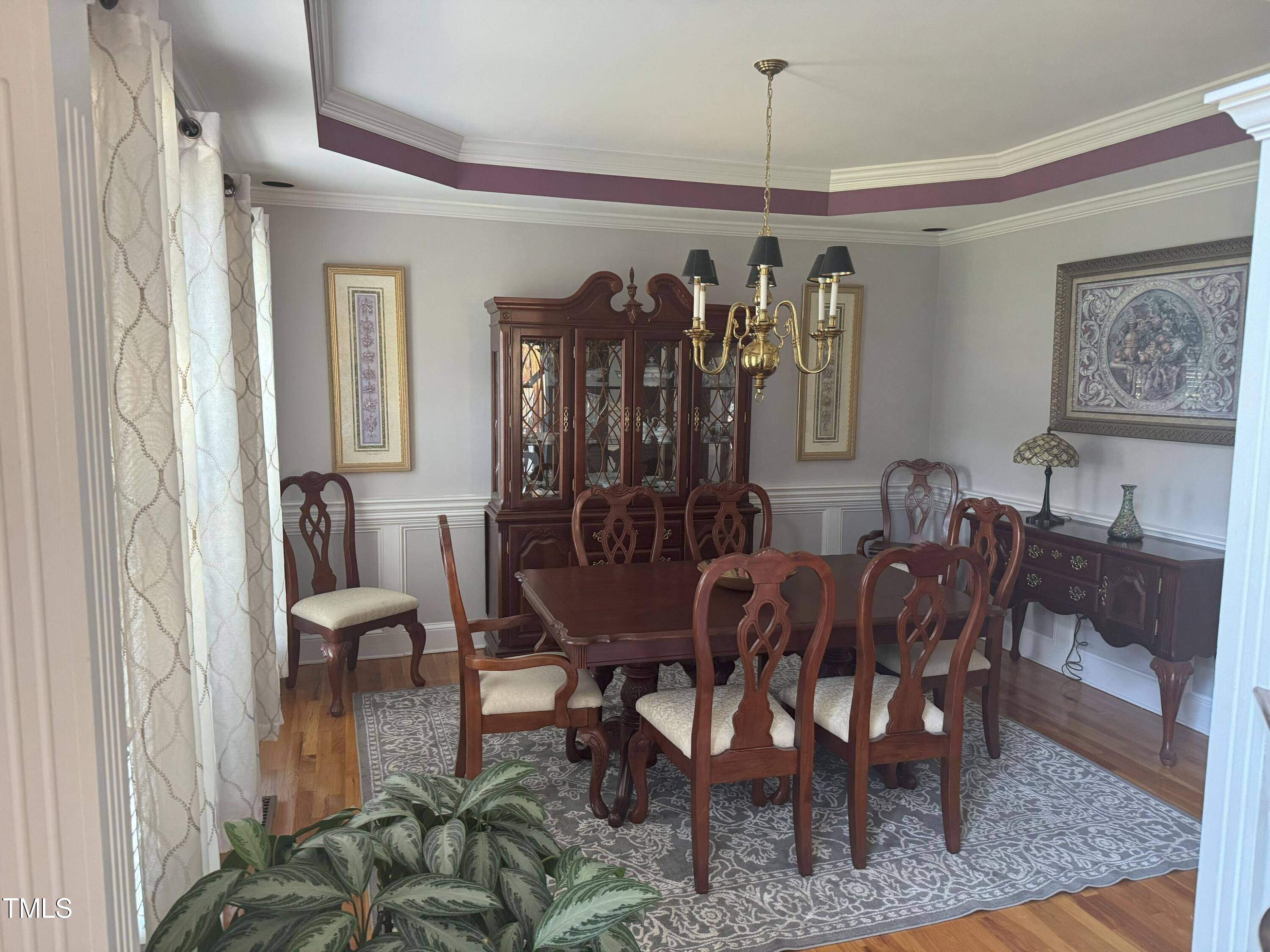 2212 Moss Pointe Lane Raleigh, NC 27606 - Photo 12 of 27 a view of a dining room with furniture window and wooden floor
