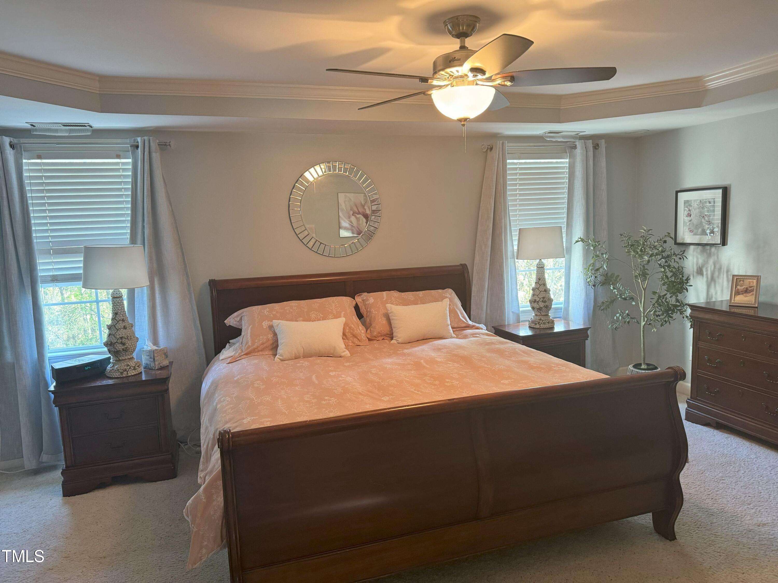 2212 Moss Pointe Lane Raleigh, NC 27606 - Photo 15 of 27 a bedroom with a bed and dresser with mirror