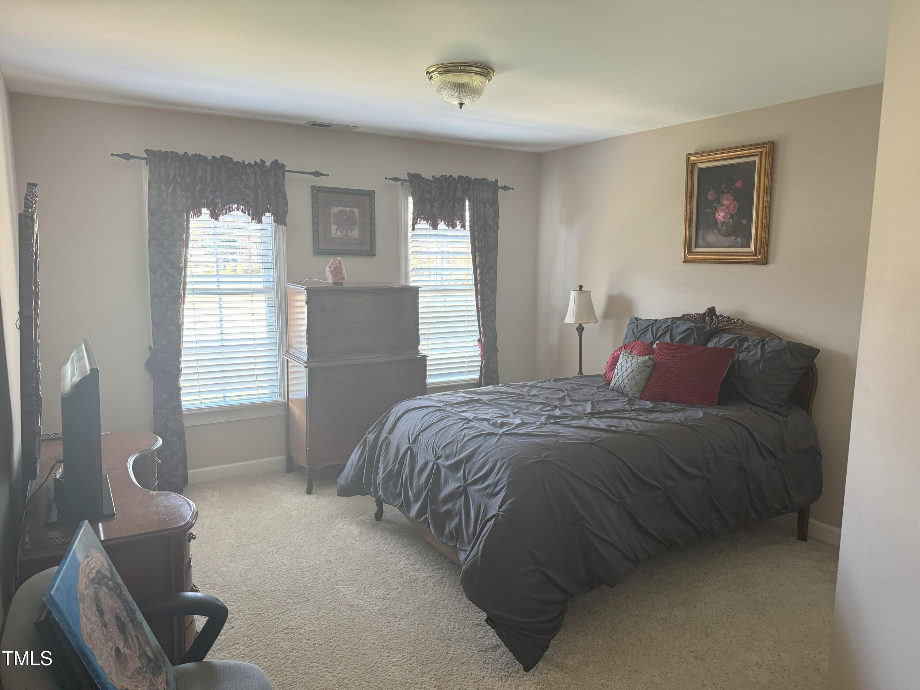 2212 Moss Pointe Lane Raleigh, NC 27606 - Photo 17 of 27 a spacious bedroom with a bed and a window