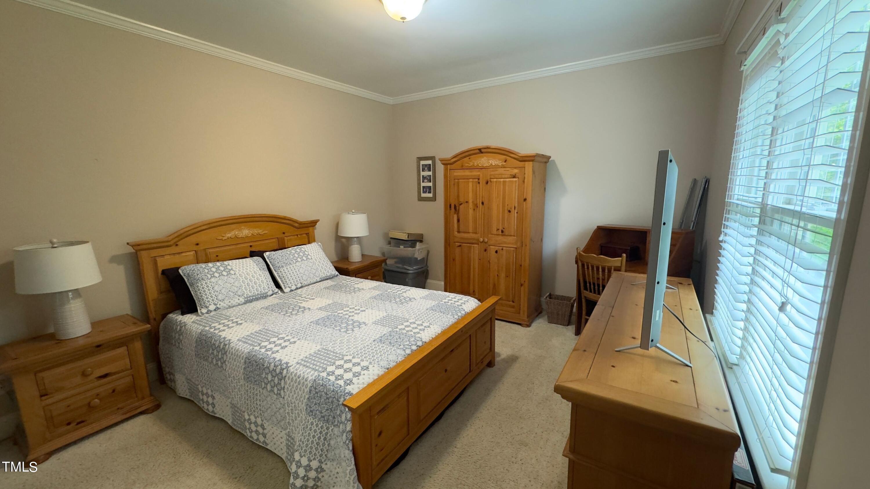 2212 Moss Pointe Lane Raleigh, NC 27606 - Photo 20 of 27 a bed sitting in a bedroom next to a window