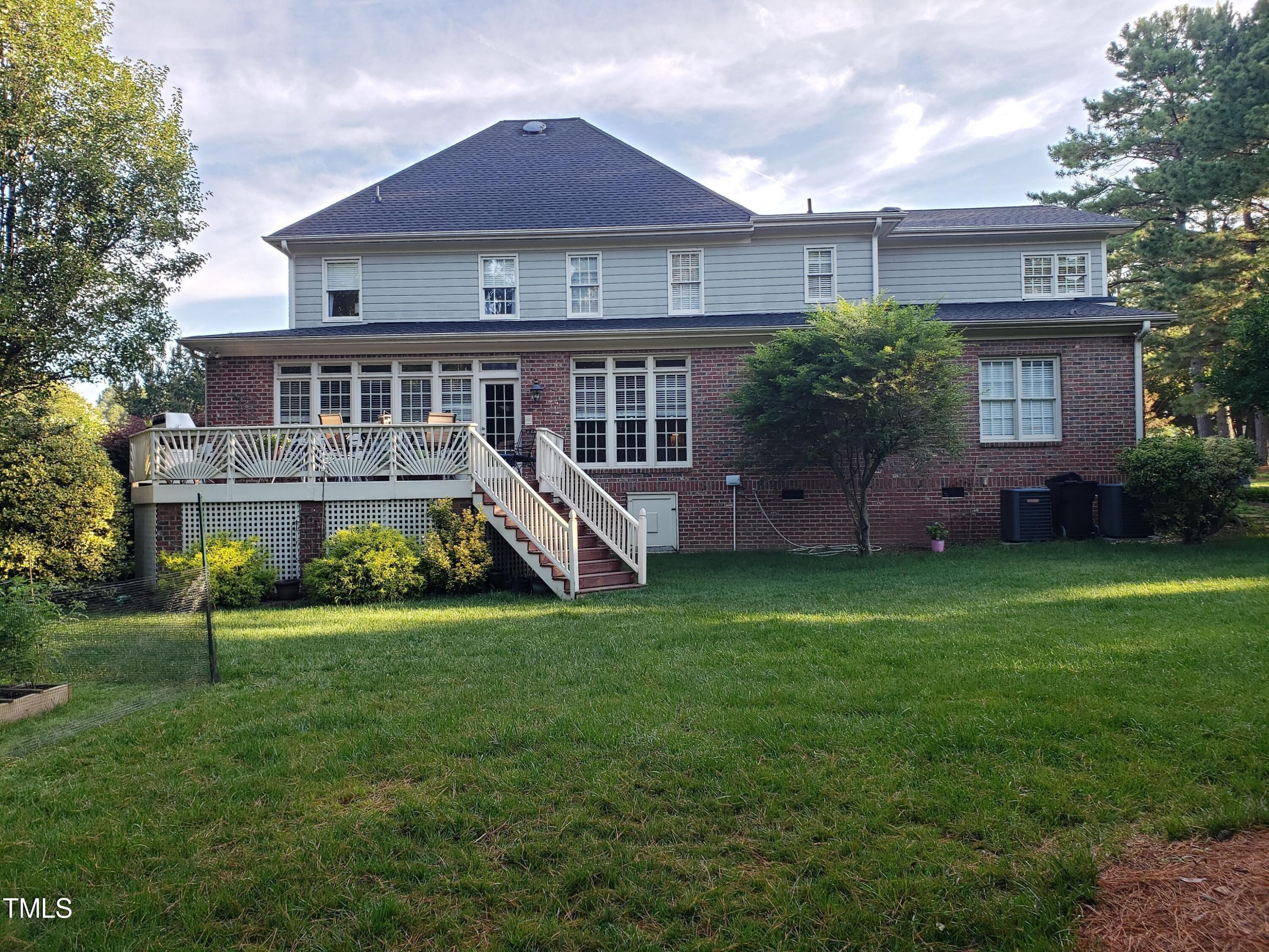 2212 Moss Pointe Lane Raleigh, NC 27606 - Photo 2 of 27 a view of a house with a yard and a deck