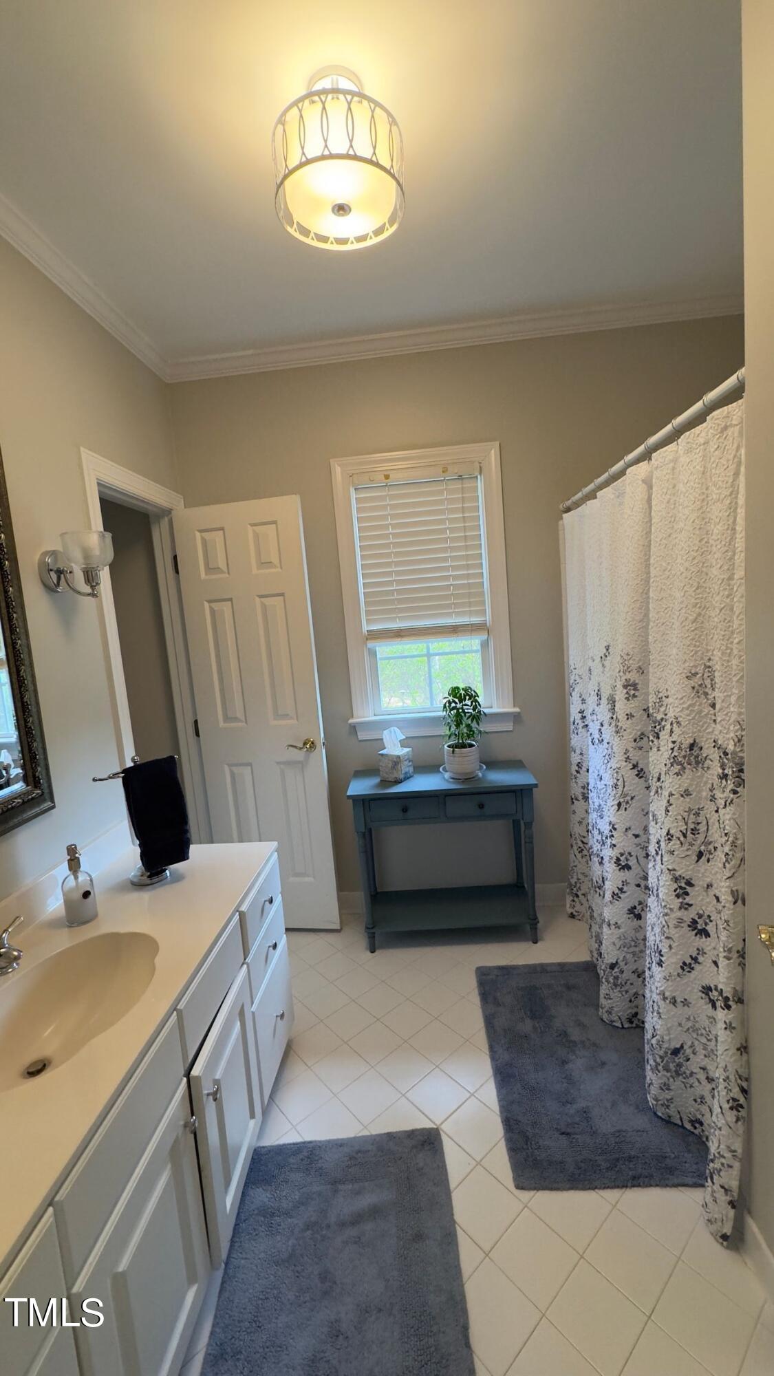 2212 Moss Pointe Lane Raleigh, NC 27606 - Photo 21 of 27 a bathroom with a sink and a mirror