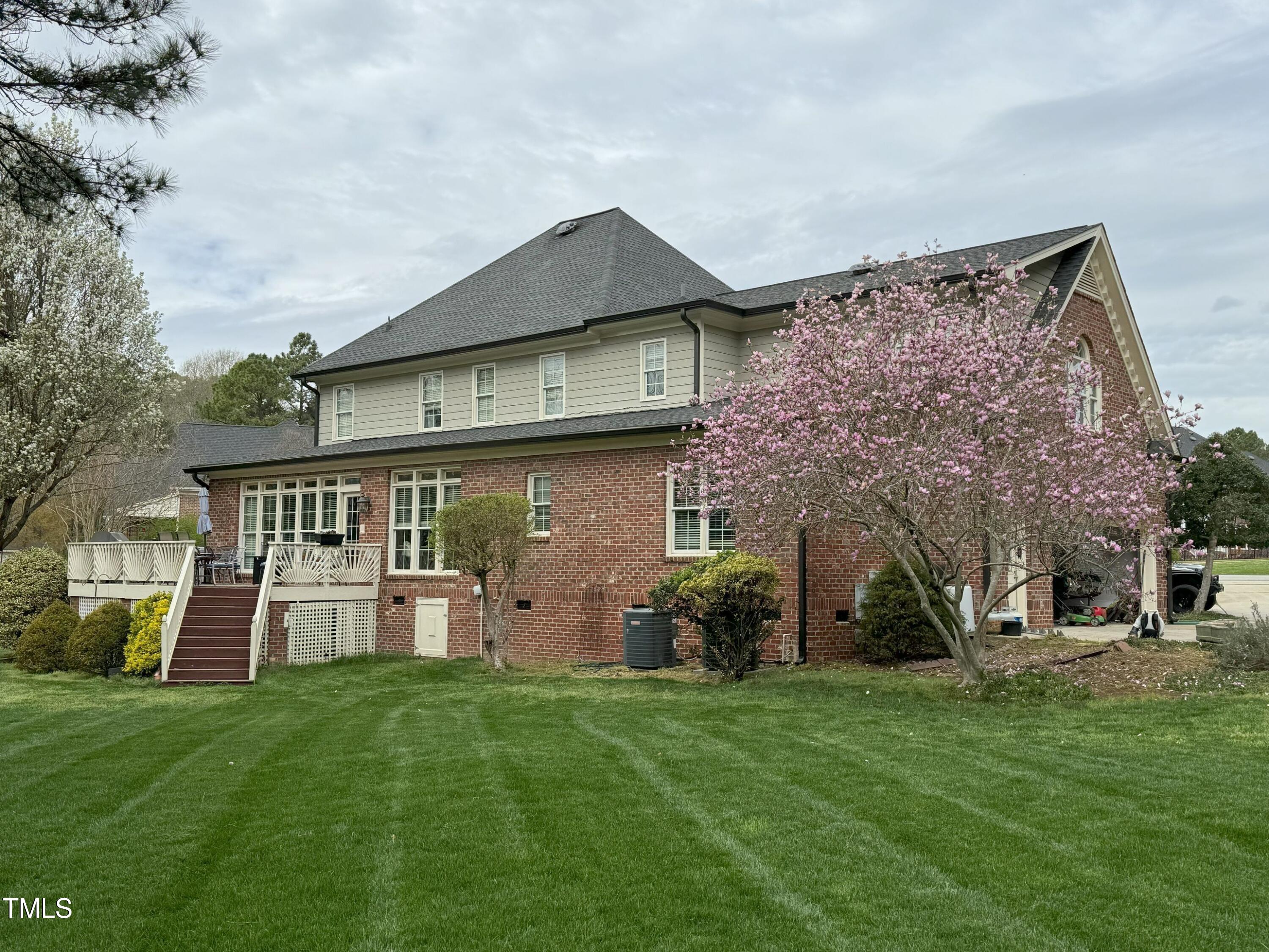 2212 Moss Pointe Lane Raleigh, NC 27606 - Photo 23 of 27 a view of a house with a big yard and large tree