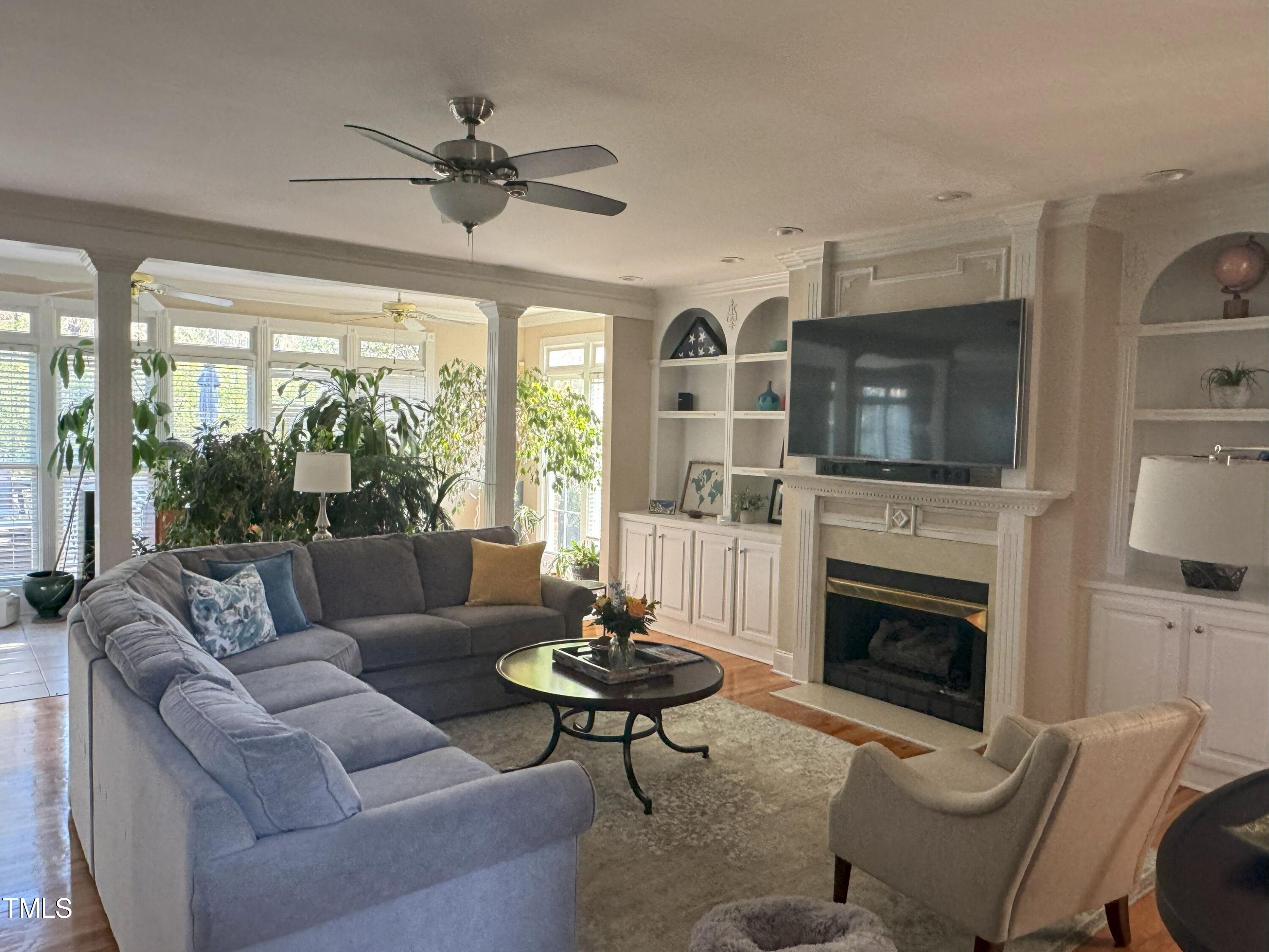 2212 Moss Pointe Lane Raleigh, NC 27606 - Photo 8 of 27 a living room with furniture fireplace and a large window