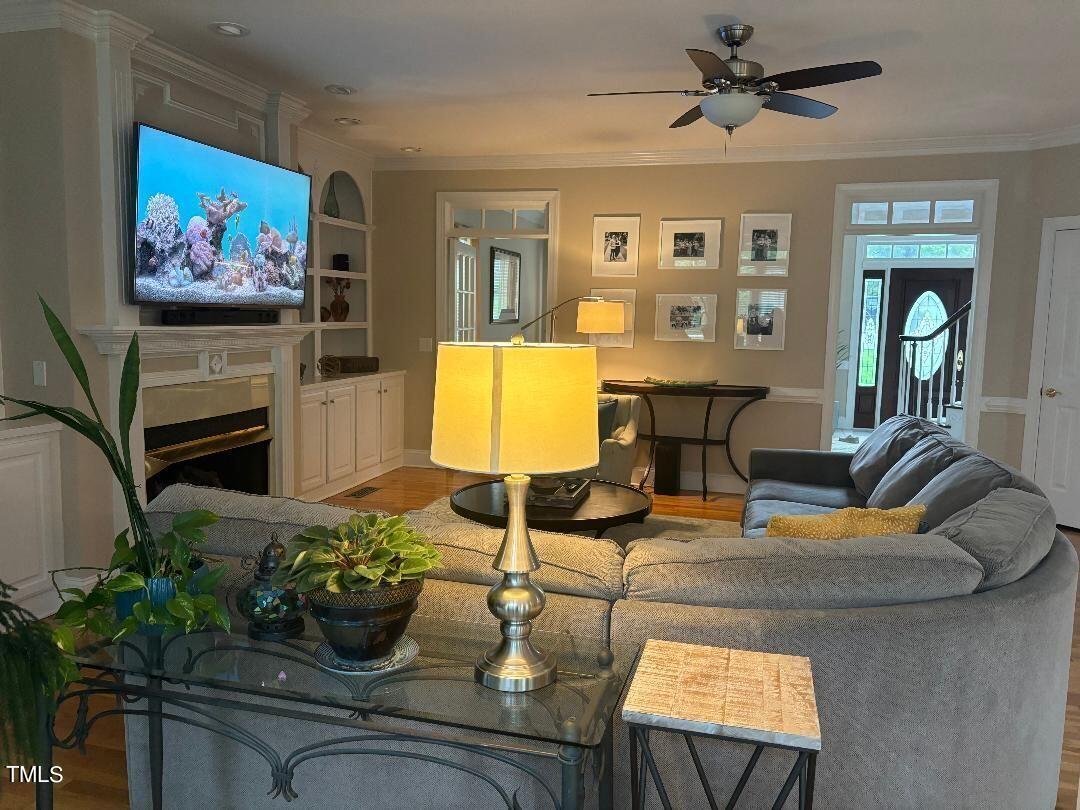 2212 Moss Pointe Lane Raleigh, NC 27606 - Photo 9 of 27 a living room with fireplace furniture and a potted plant