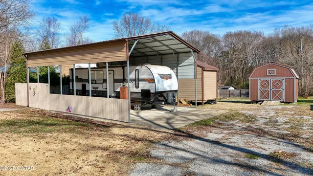 a view of a house with a yard and wooden fence