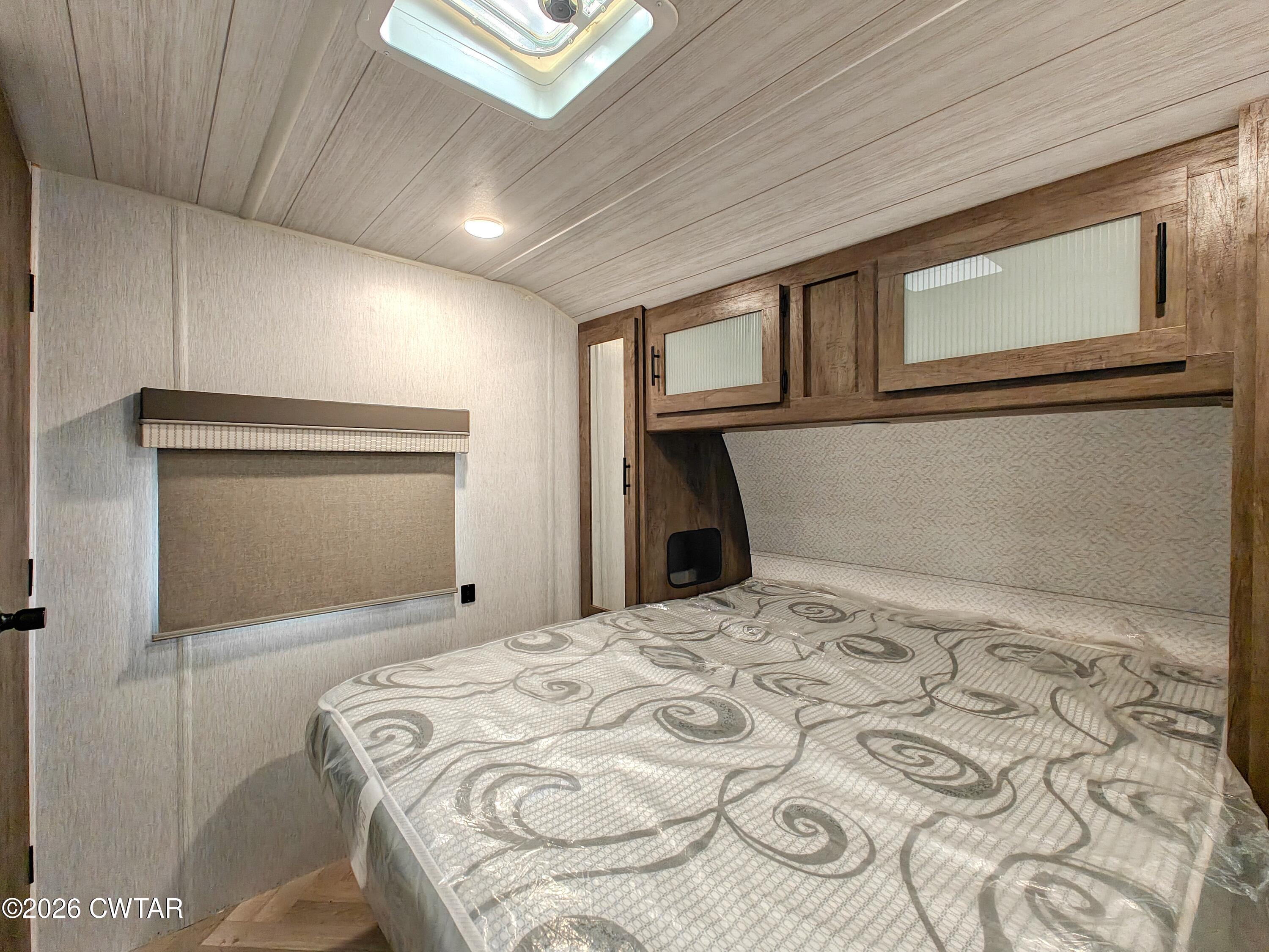 202 Eva Beach Drive Eva, TN 38333 - Photo 14 of 34 a bedroom with a bed and a window