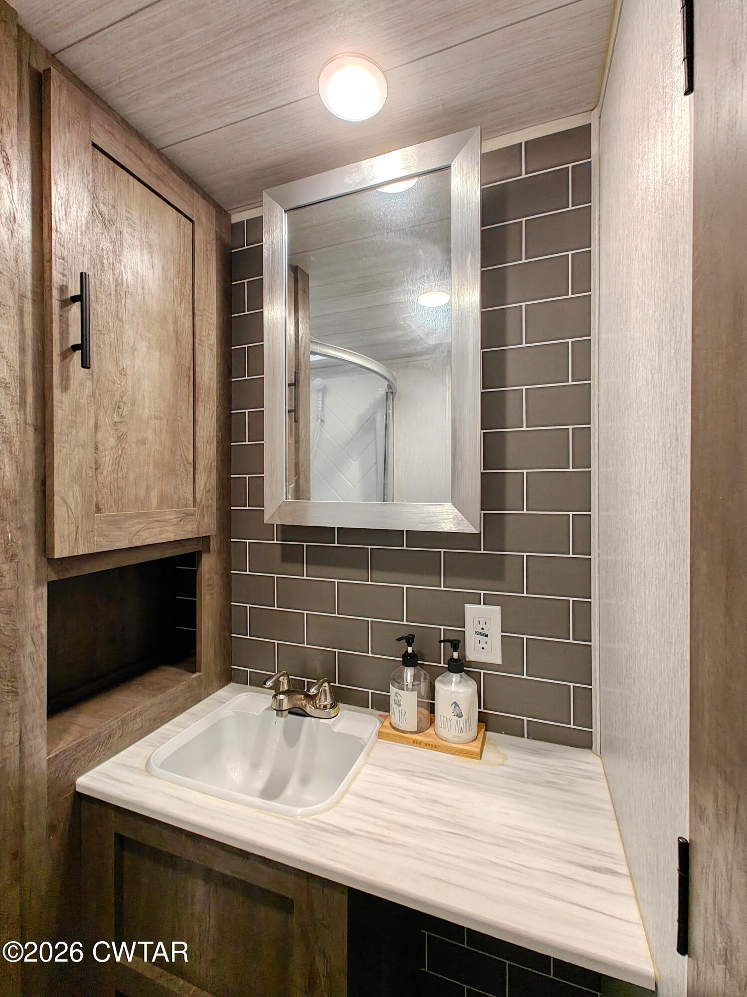 202 Eva Beach Drive Eva, TN 38333 - Photo 16 of 34 a bathroom with a sink and a mirror