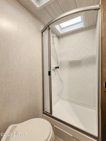 a bathroom with a toilet and shower