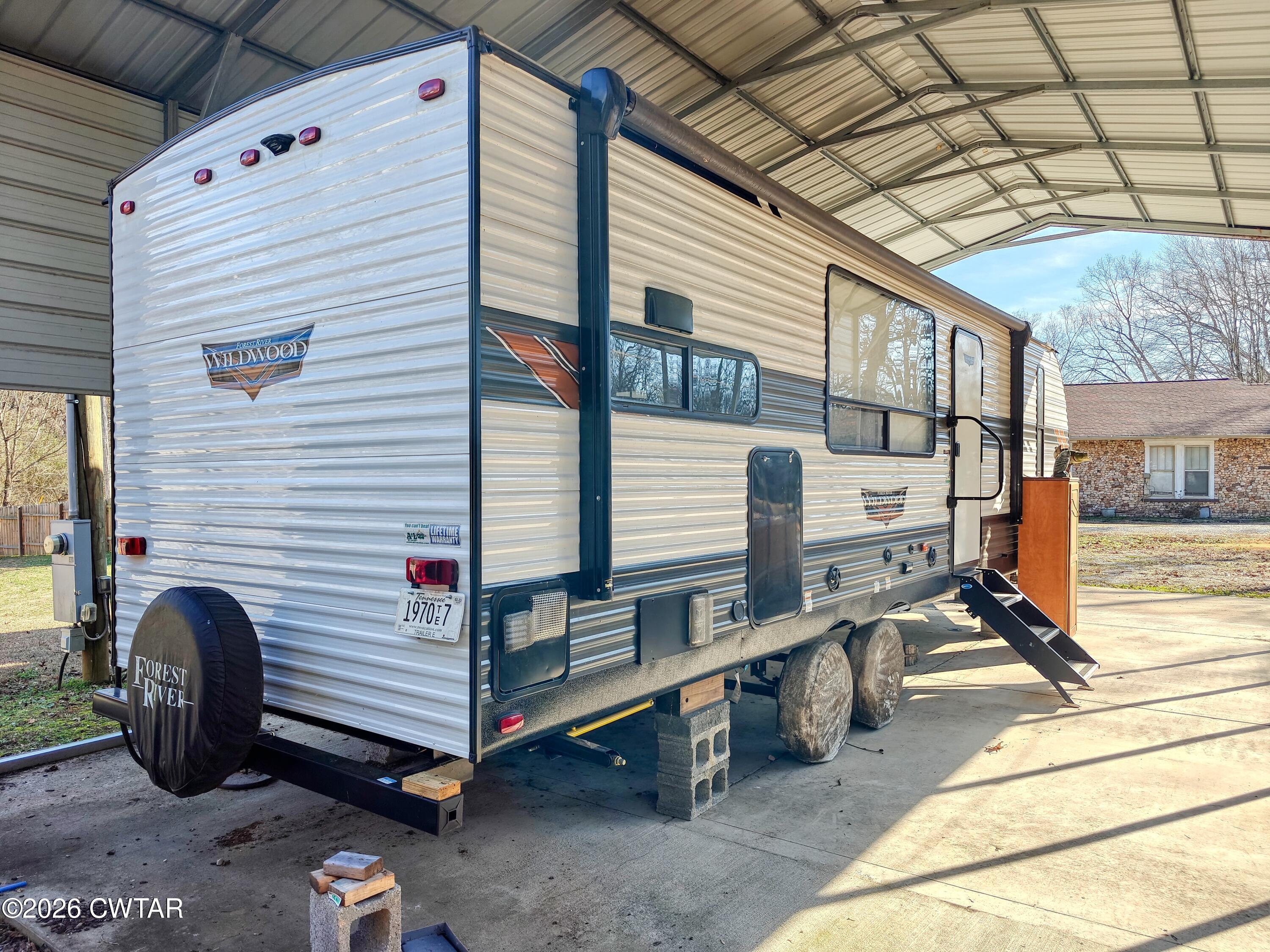 202 Eva Beach Drive Eva, TN 38333 - Photo 4 of 34 a backyard of a house with barbeque oven table and chairs