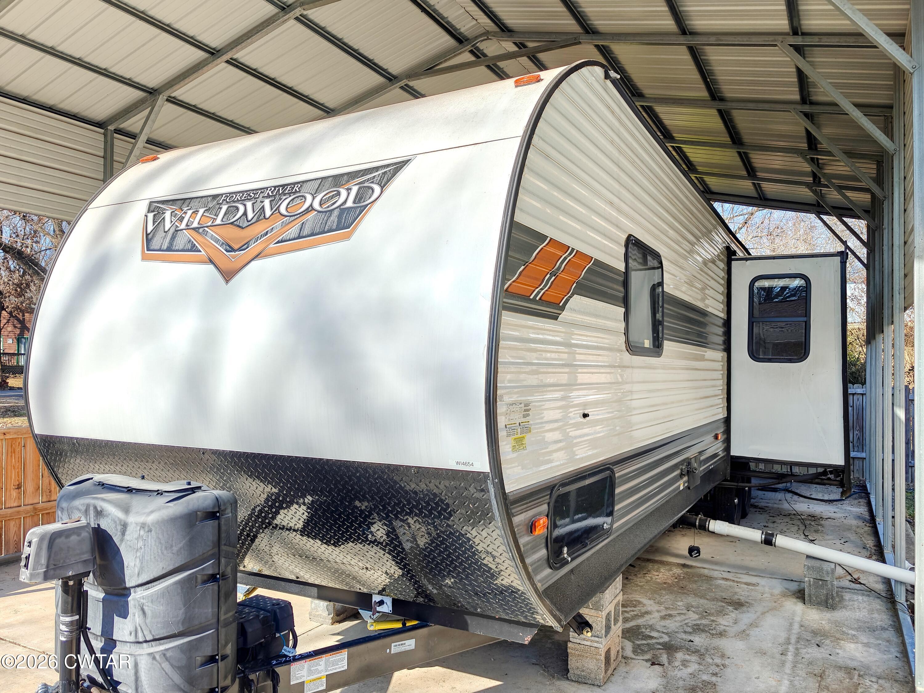 202 Eva Beach Drive Eva, TN 38333 - Photo 5 of 34 a view of a garage with wooden wall