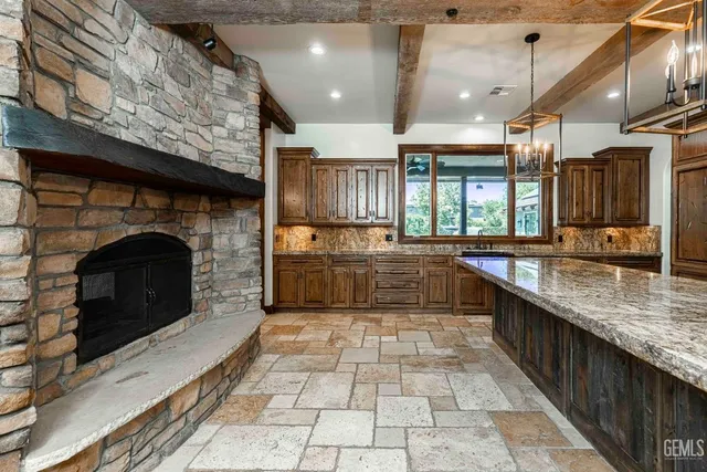 a kitchen with granite countertop a stove and a microwave