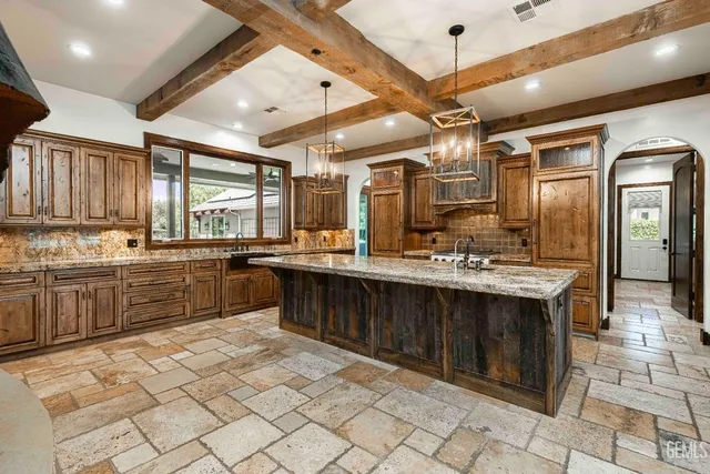 a living room with a fireplace and a floor to ceiling window