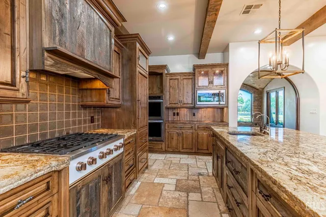 a view of an empty room with a fireplace and a window