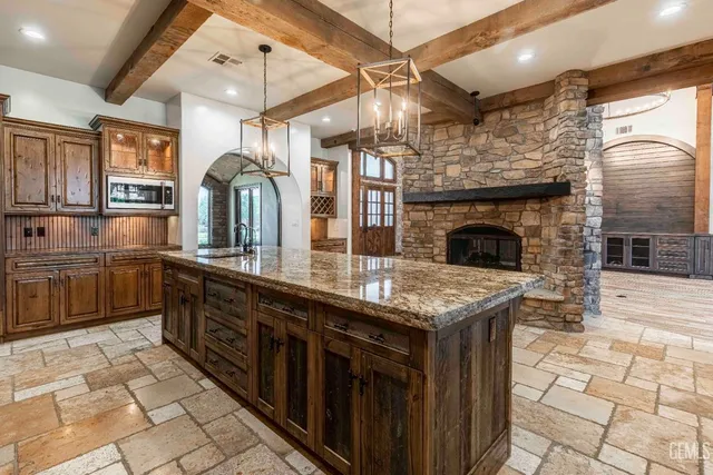 a bathroom with a granite countertop sink and a bathtub