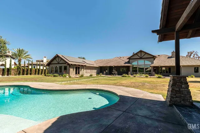 a view of swimming pool with outdoor seating