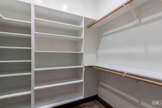 a view of a patio with table and chairs under an umbrella