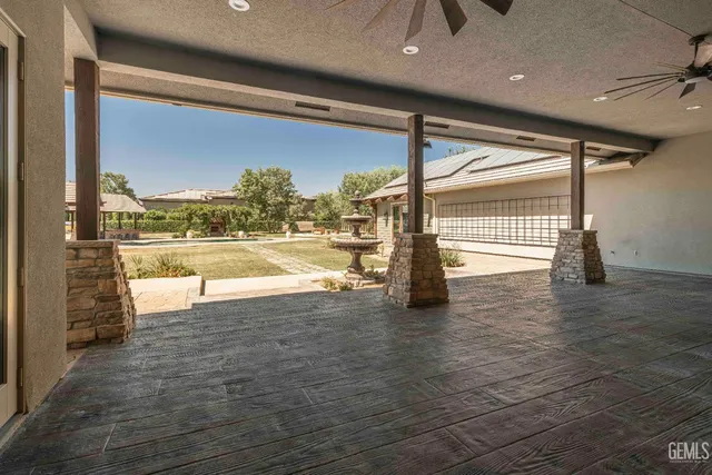 a view of a house with wooden floor next to a yard