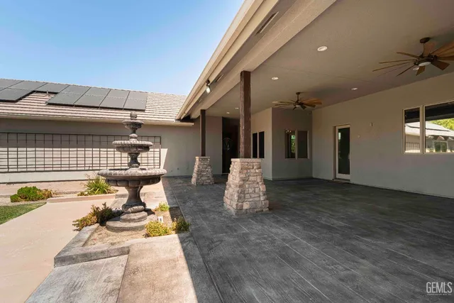 a view of a porch with a table and chairs
