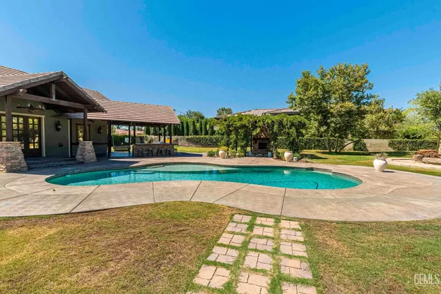 a view of a swimming pool with an outdoor space and seating area