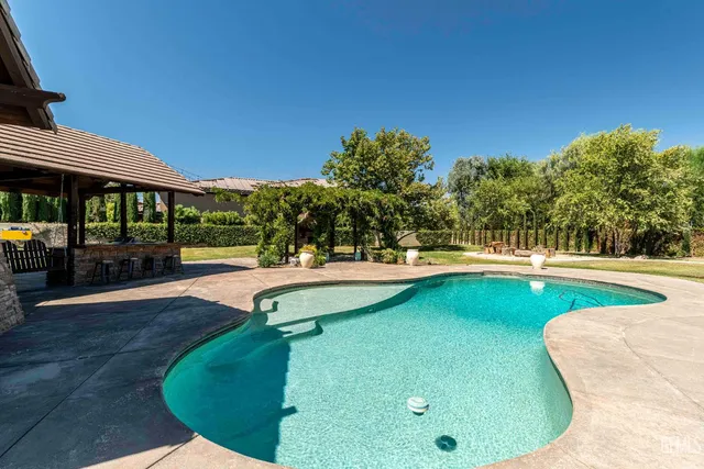 a bathroom with a granite countertop sink a toilet and a mirror