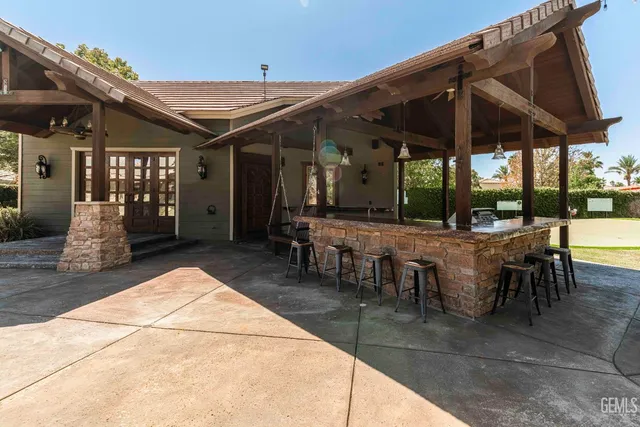a bathroom with a granite countertop sink vanity and mirror