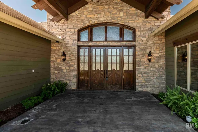 a view of an empty room with wooden floor and a fireplace