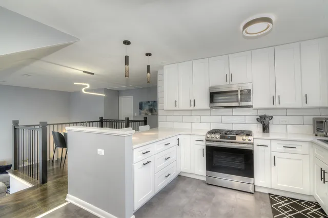 a kitchen with a stove top oven and cabinets