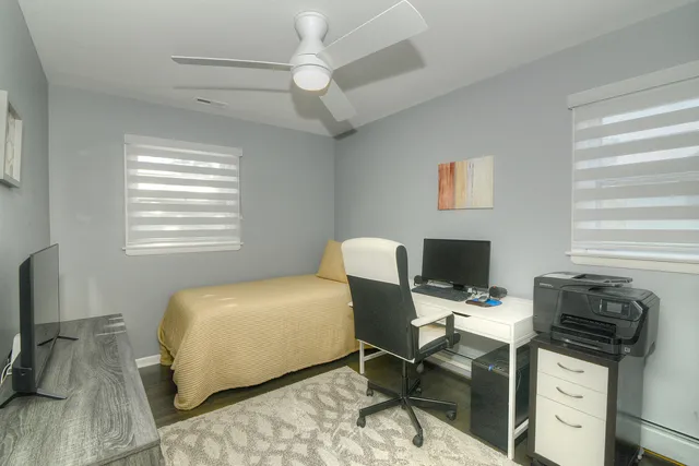 a bedroom with a workspace