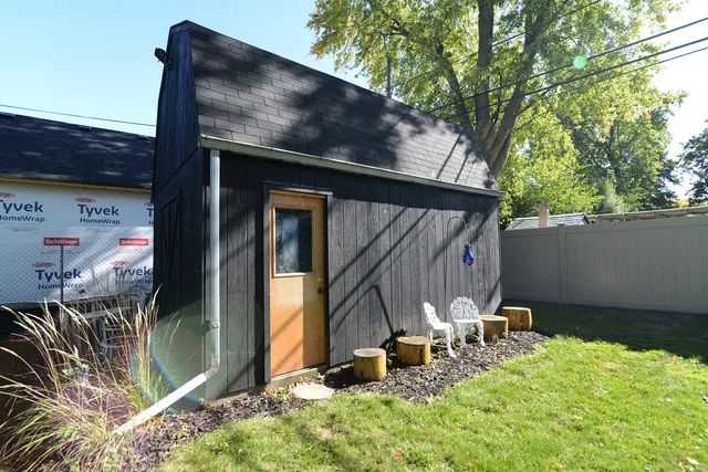 a front view of a house with yard porch and furniture