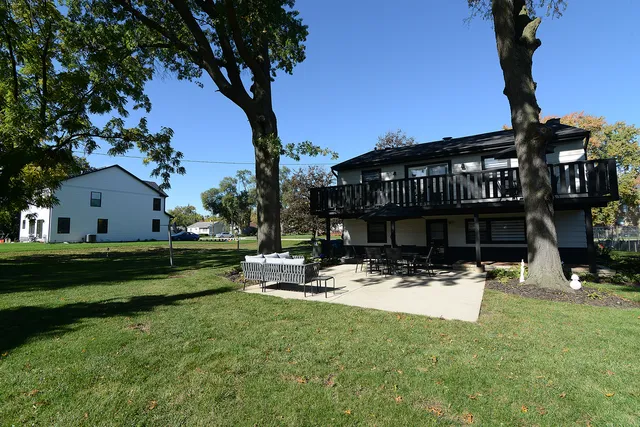 a view of a patio with table and chairs under an umbrella