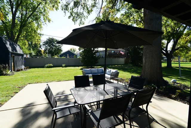 a front view of a house with a garden and yard