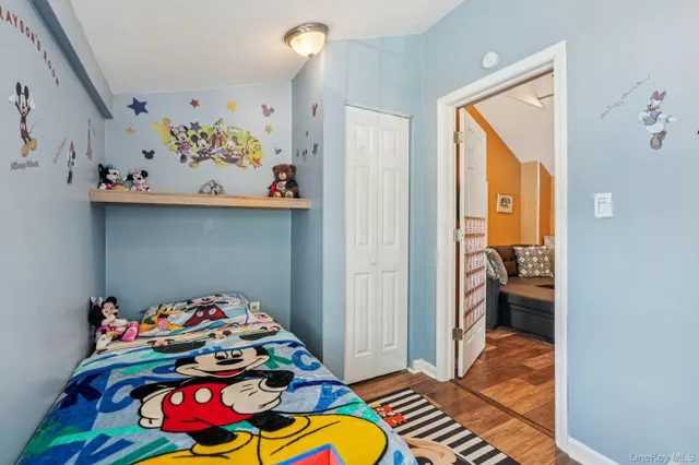 a bedroom with furniture and a flat screen tv