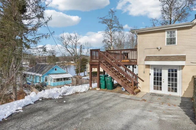 a view of a house with a yard and wooden fence