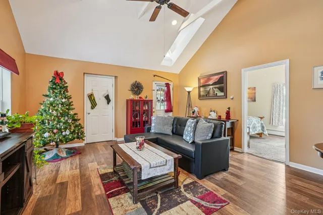 a living room with furniture and a potted plant