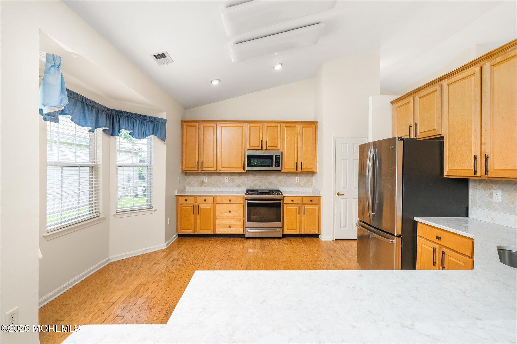 10 Powderhorn Way Allentown, NJ 08501 - Photo 10 of 27 a kitchen with stainless steel appliances kitchen island granite countertop a refrigerator and a stove top oven