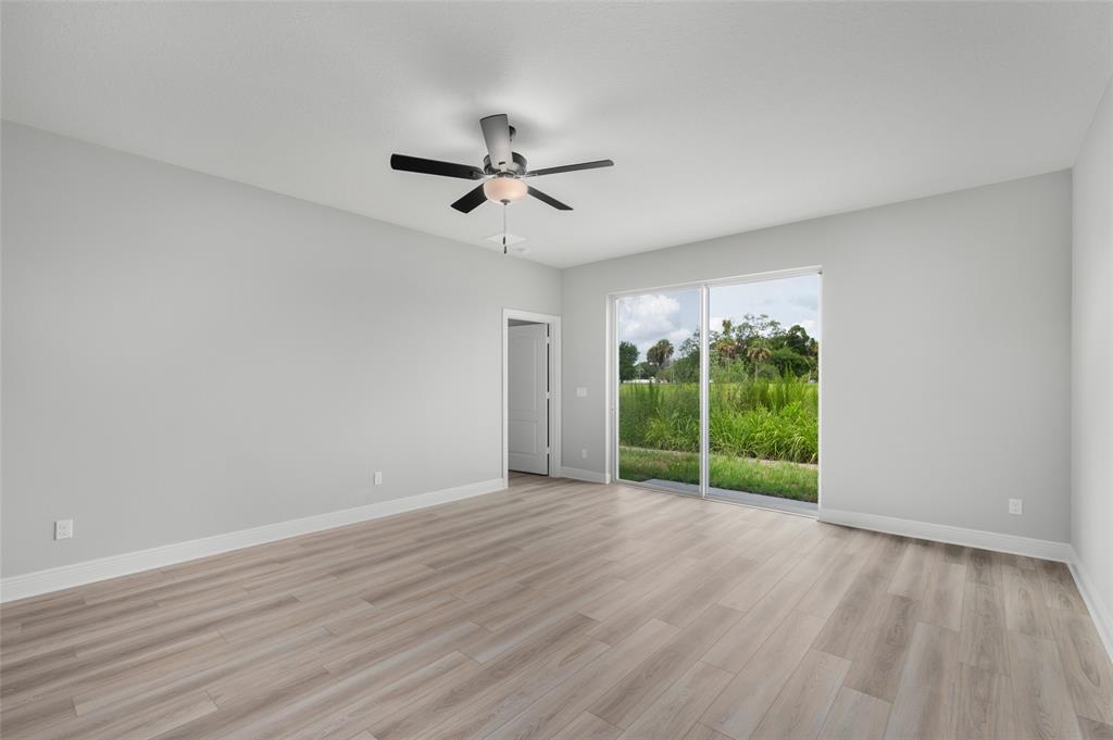 1813 Gaiety Way Fort Pierce, FL 34947 - Photo 7 of 16 a view of a big room with wooden floor and windows