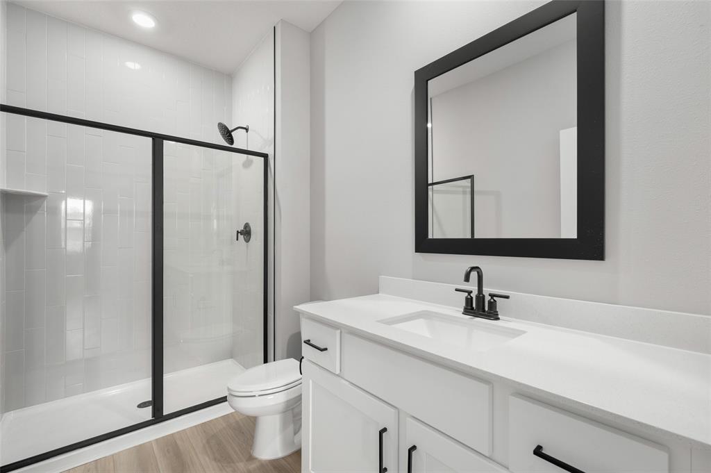 1813 Gaiety Way Fort Pierce, FL 34947 - Photo 10 of 16 a bathroom with a toilet a sink and a mirror