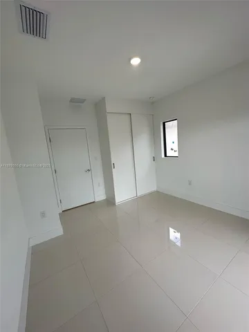 a view of an empty room with closet