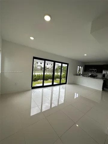 a view of a hallway to rooms